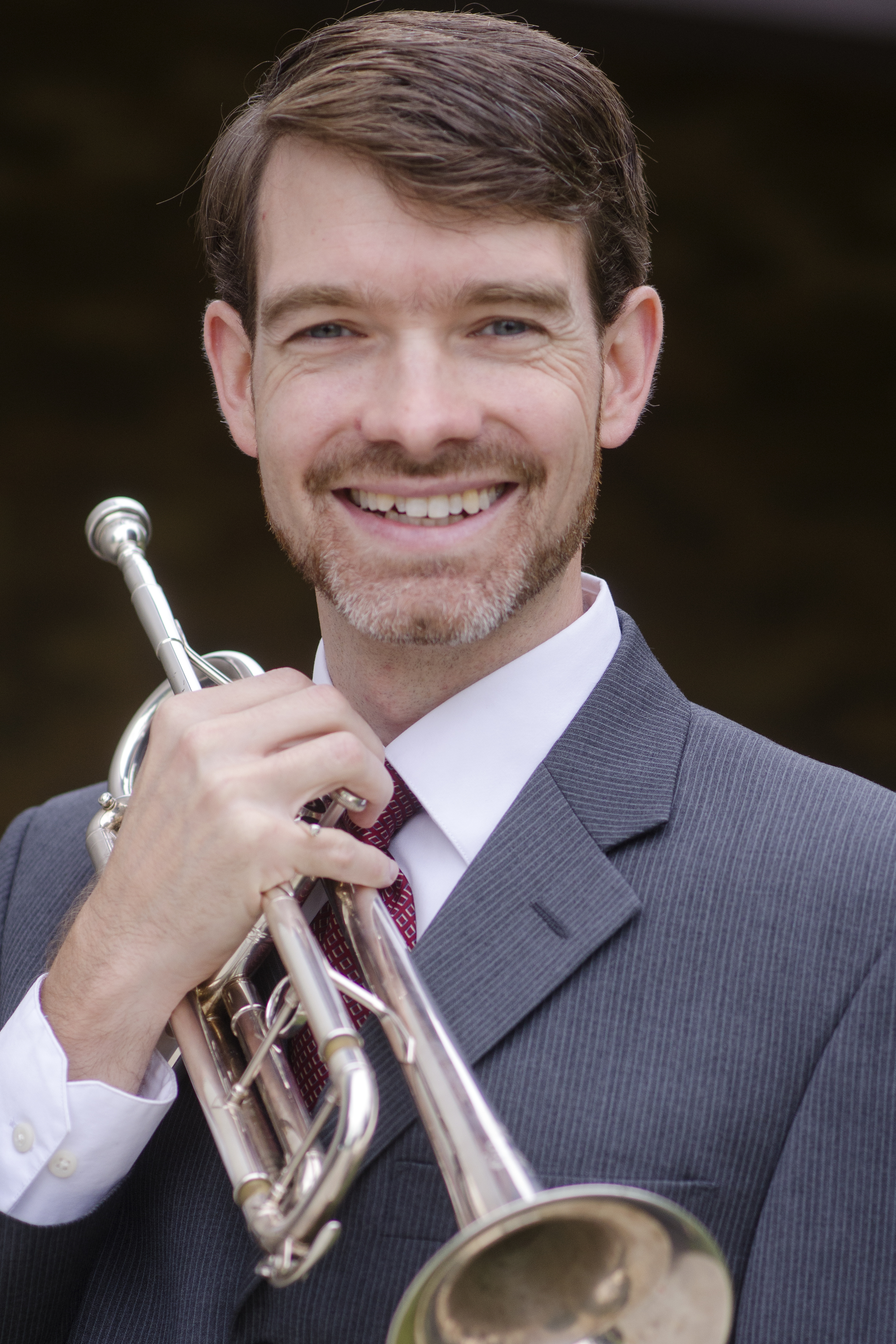 BrianReichenbach headshot with trumpet